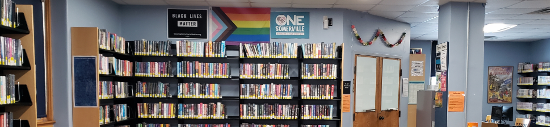 A panoramic snapshot taken of one side of the Central Library Teen Room, featuring the teen fiction stacks and teen computers in the distance.