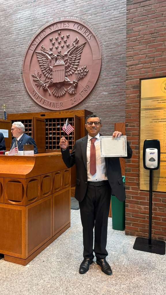A photo of Arlindo holding a US flag.